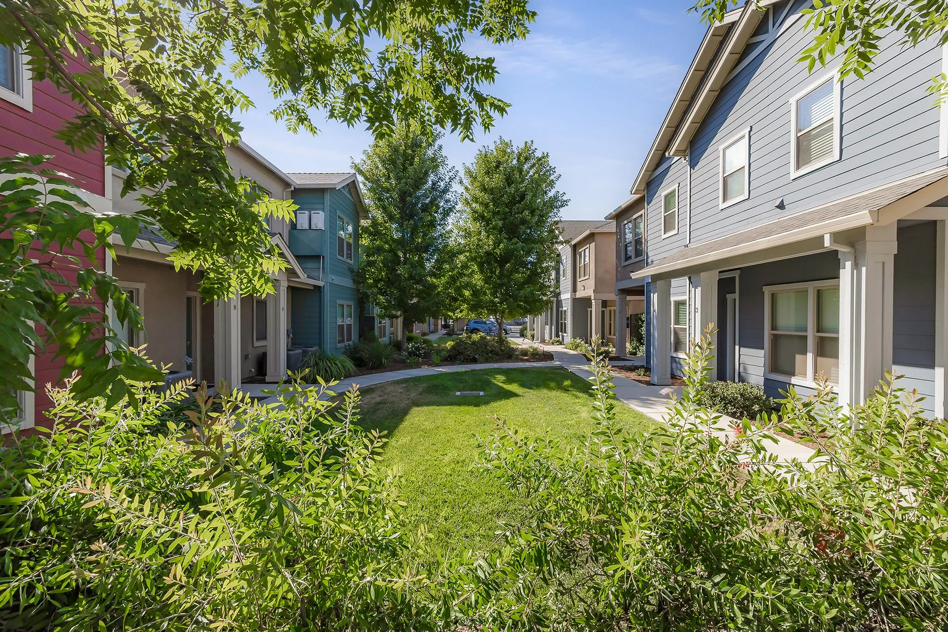 Uptown Place Apartments courtyard with colorful buildings and landscaped grounds in Chico, CA